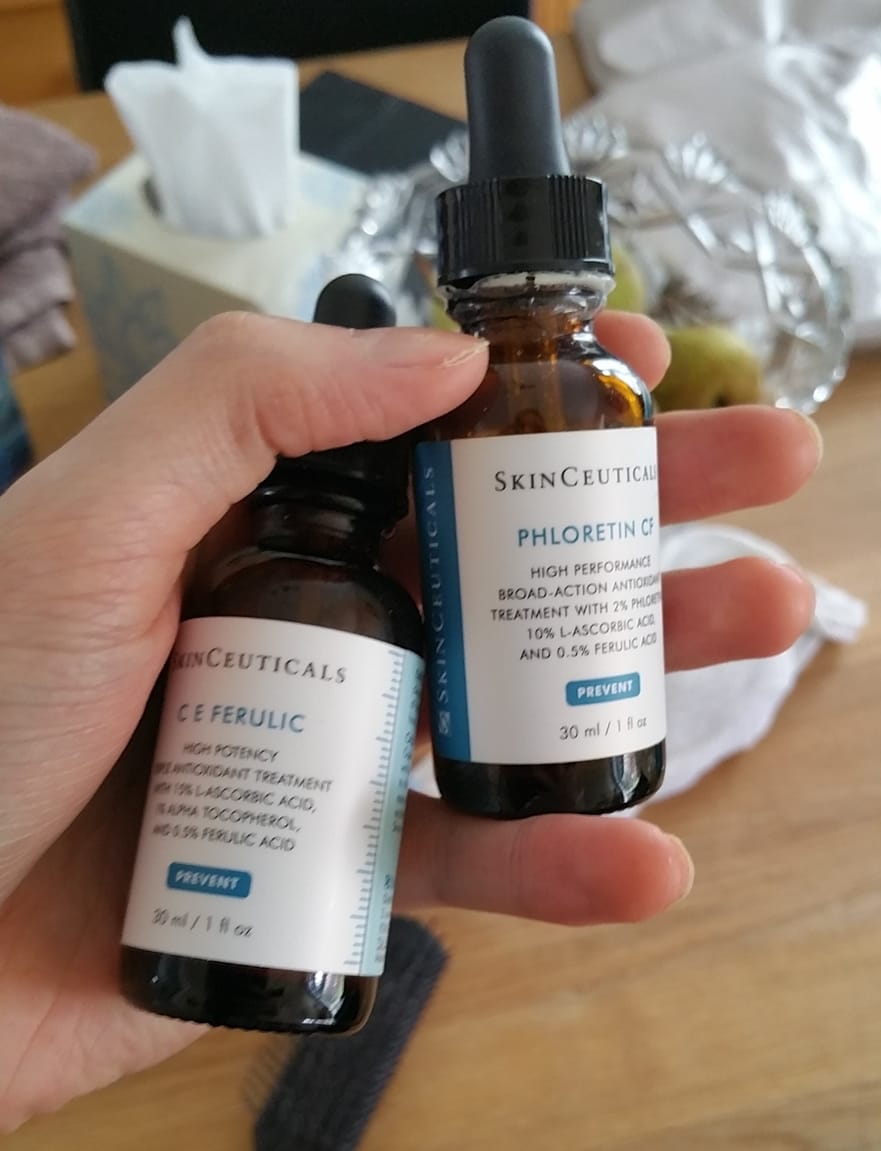 holding bottles of ce ferulic and phloretin cf 